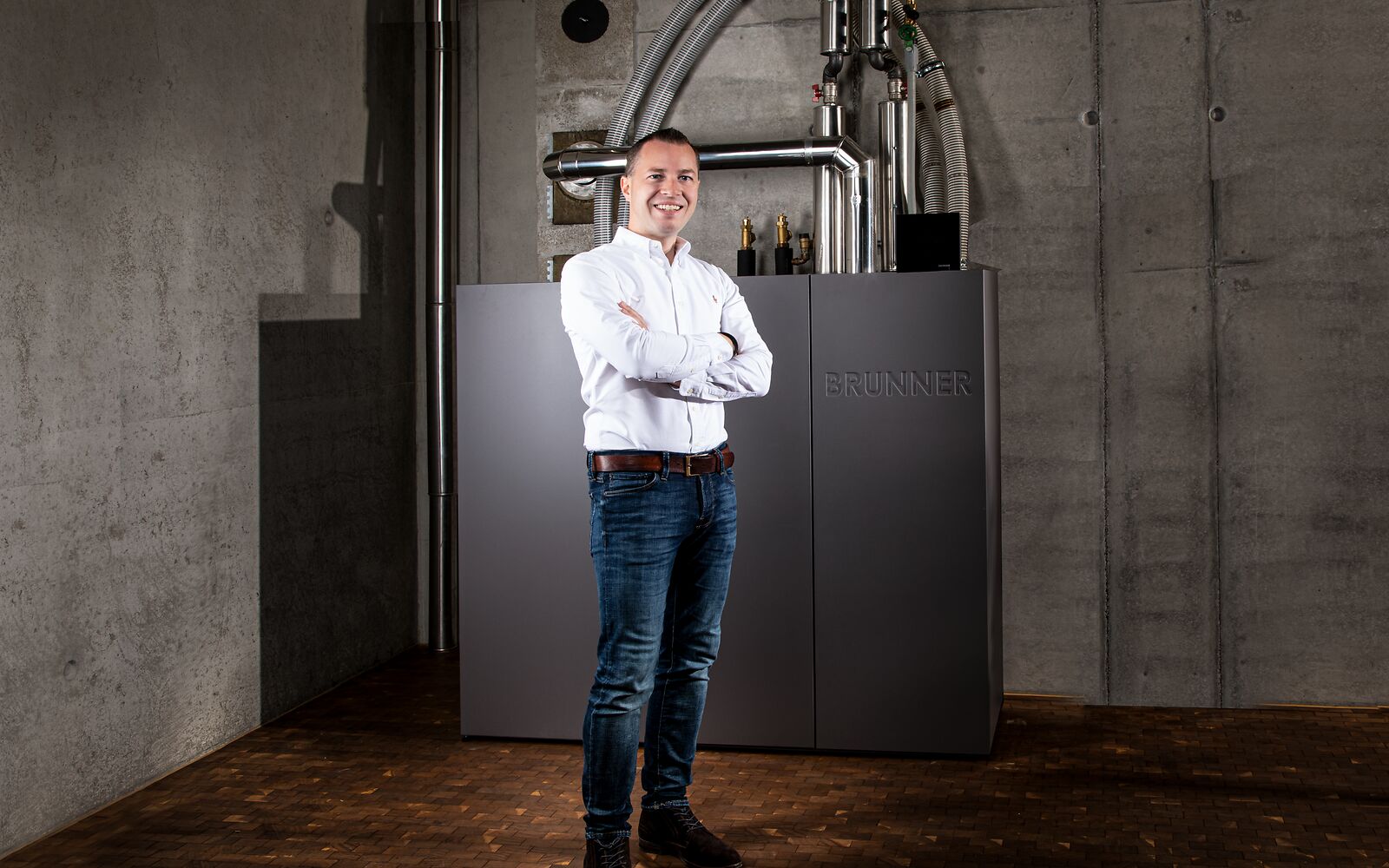 Hubertus Brunner im Heizraum vor dem Pelletkessel