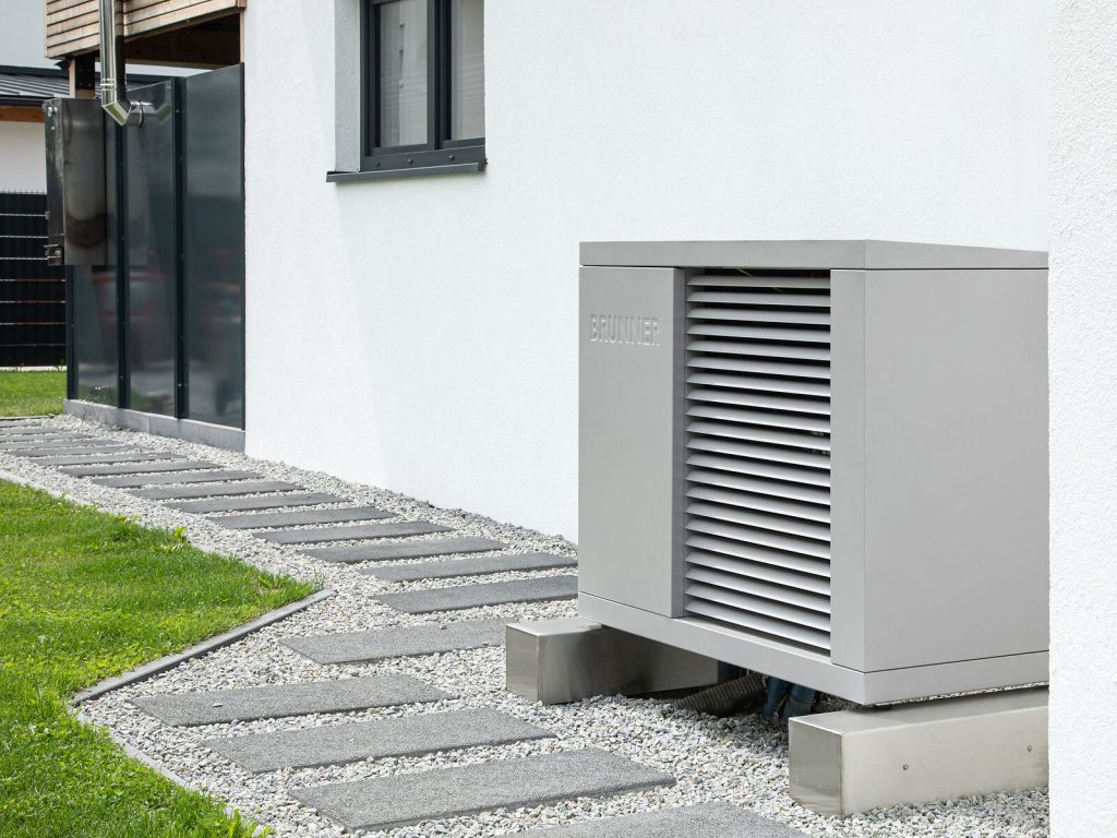 Heat pump in front of a house wall
